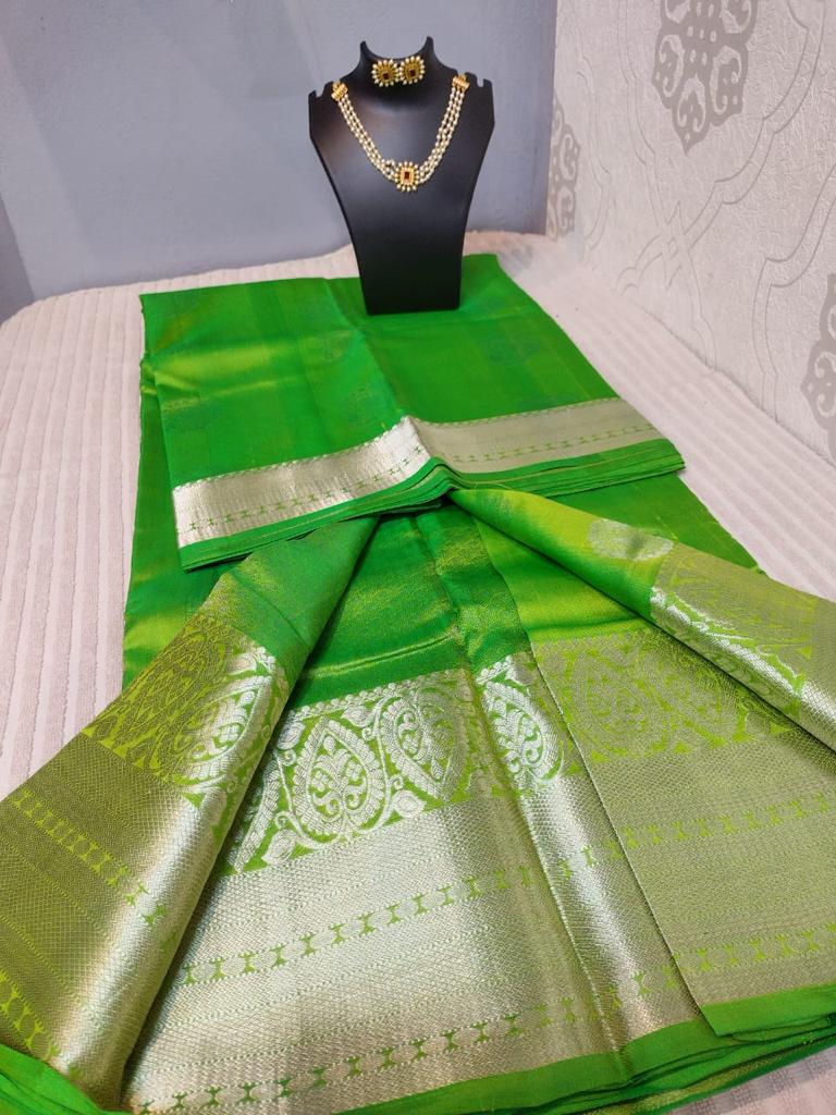 Kanjivaram silk saree in parrat green color with silver jari butties