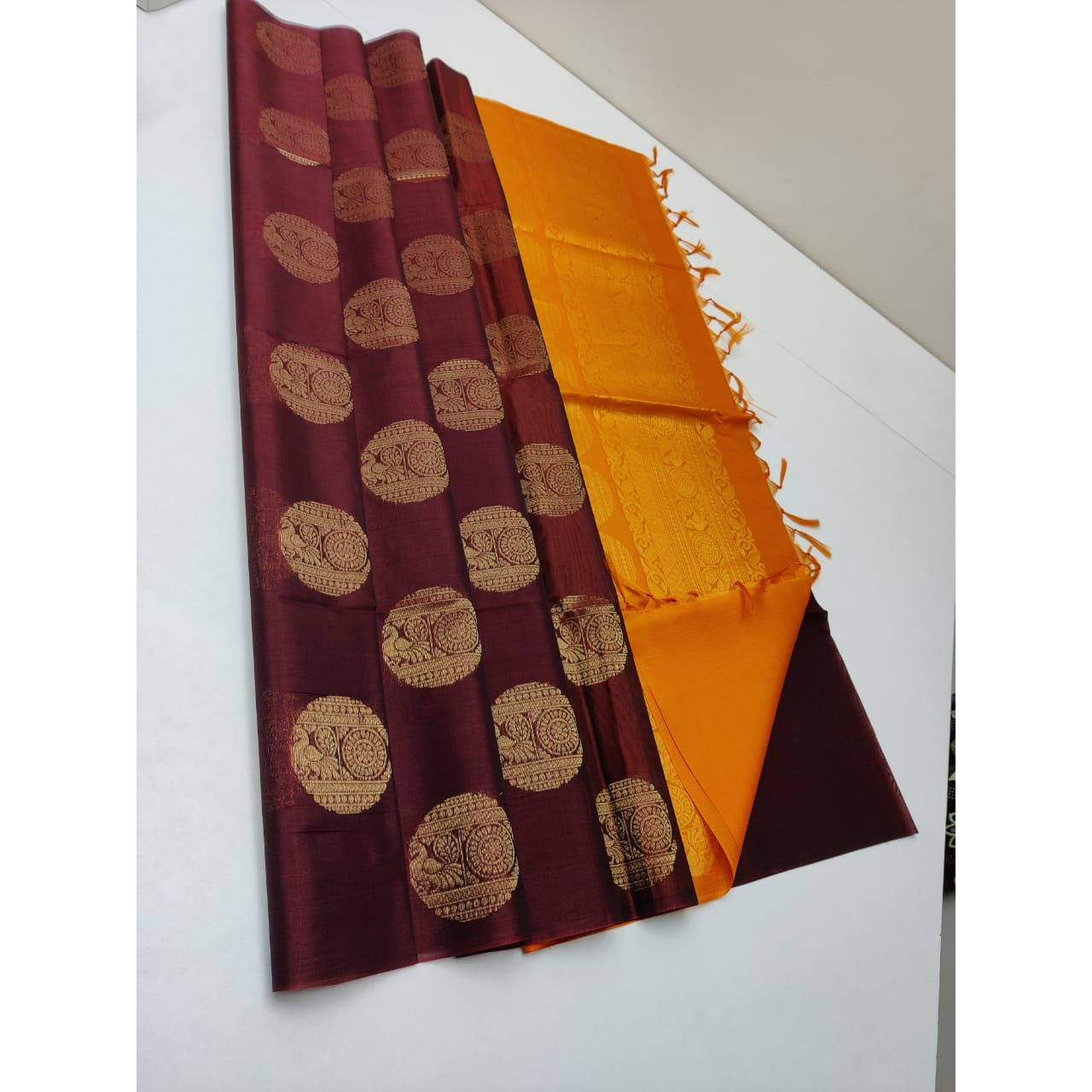 Cotton silk pure borderless in maroon and orange color with golden butti