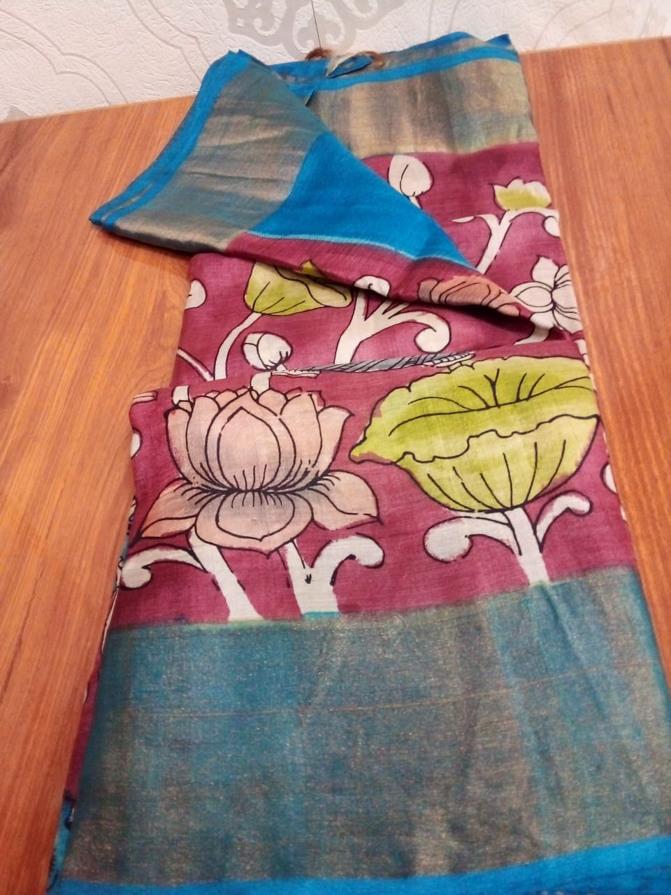 Hand painted Pen Kalamkari in Pure Zari Tussar Saree maroon with Pink border with lotus flowers with fish story