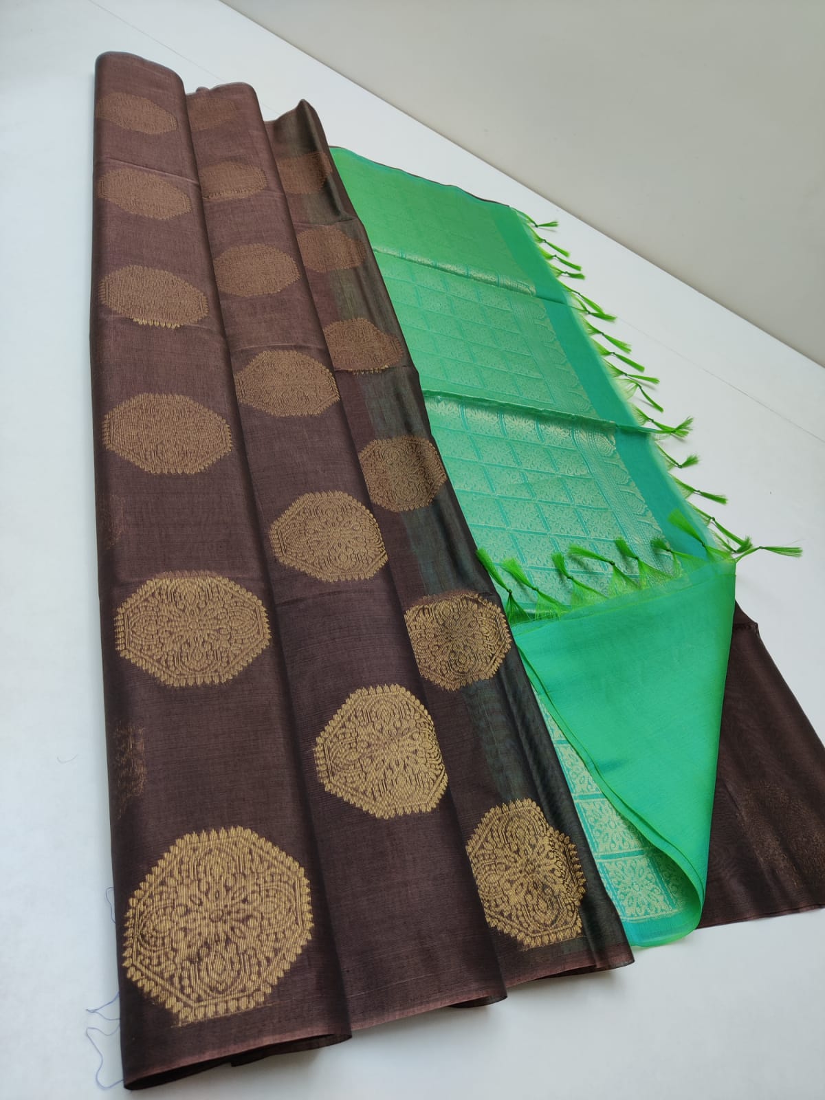 Cotton silk pure borderless in dark coffee color with round butti and green mundi