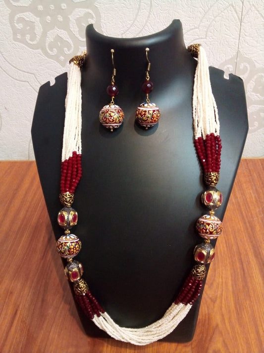 Jewellery cream with maroon sugar beads in with golden nuts