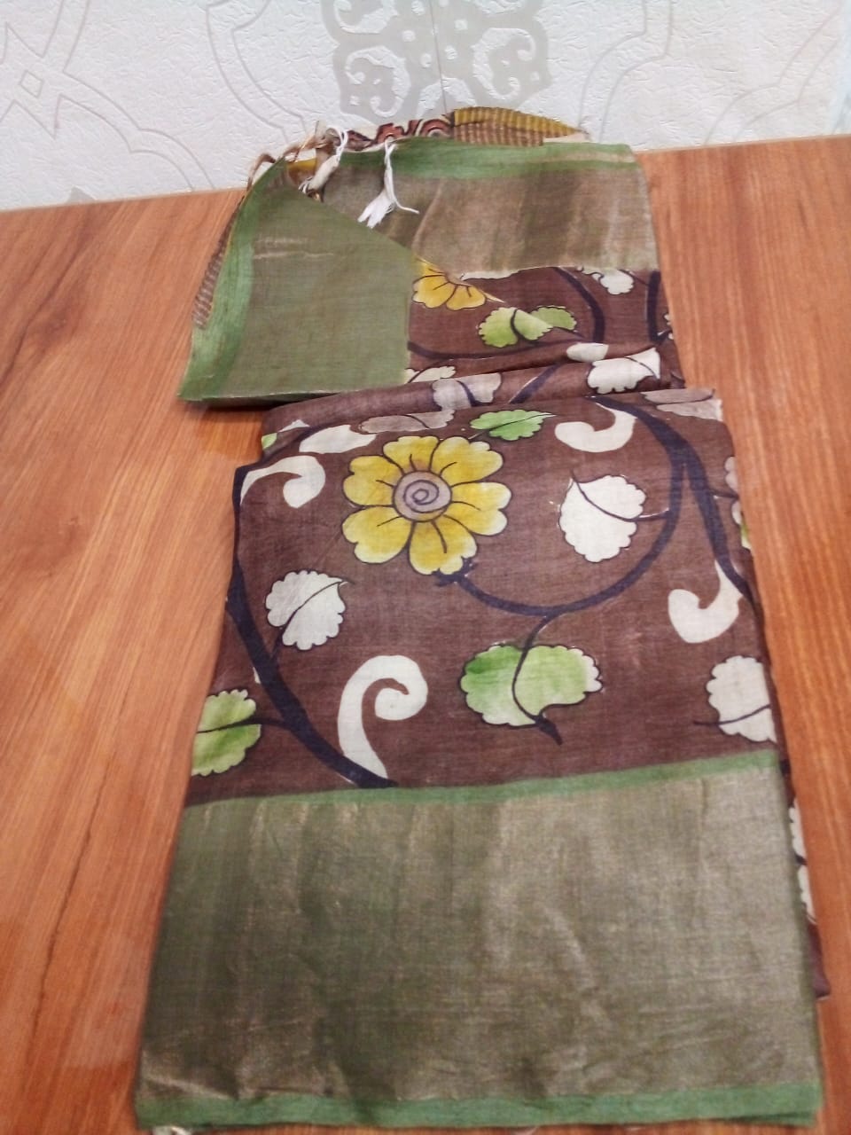 Hand painted Pen Kalamkari in Pure Zari Tussar Saree Brown with Green border with flowers story